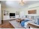 Bright living room featuring hardwood floors, a chandelier, built in shelves, and comfortable seating at 18109 Kara Ct, Tampa, FL 33647