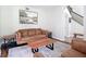Comfortable living room featuring a leather sofa, area rug, and wood coffee table at 18109 Kara Ct, Tampa, FL 33647