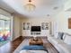 Bright living room featuring a large sofa, built-in shelving, and sliding glass doors to the outdoor patio at 18109 Kara Ct, Tampa, FL 33647