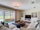 Cozy living room with a large sectional sofa, custom built-ins, and a view of the backyard at 18109 Kara Ct, Tampa, FL 33647