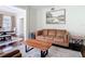 Comfortable living room featuring a plush brown sofa, wooden side tables, and stylish decor at 18109 Kara Ct, Tampa, FL 33647