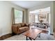 Inviting living room with a leather sofa, wood coffee table, and access to a dining area at 18109 Kara Ct, Tampa, FL 33647