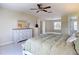 Bright and open bedroom features ceiling fan, neutral carpet and walk-in closet access at 18109 Kara Ct, Tampa, FL 33647