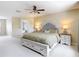 Carpeted bedroom features ceiling fan and a decorative headboard with neutral paint at 18109 Kara Ct, Tampa, FL 33647