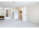 Bright and airy main bedroom with neutral carpet and an adjoining doorway to a room at 18109 Kara Ct, Tampa, FL 33647