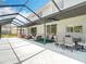 Spacious screened-in patio area featuring comfortable seating, a dining table, and an open design at 18109 Kara Ct, Tampa, FL 33647