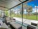 Screened-in patio with golf course views, featuring a comfortable seating area at 18109 Kara Ct, Tampa, FL 33647