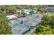 Aerial view of the community tennis courts surrounded by lush trees and the community pool at 18109 Kara Ct, Tampa, FL 33647