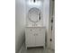 Stylish half bathroom featuring a modern vanity with white marble countertop, brushed gold fixtures, and decorative wallpaper at 18875 Noble Caspian Dr, Lutz, FL 33558