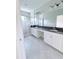 Bathroom featuring a double vanity with granite countertop and a tiled walk-in shower at 18875 Noble Caspian Dr, Lutz, FL 33558