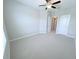 Bright, carpeted bedroom with a ceiling fan and ample natural light at 18875 Noble Caspian Dr, Lutz, FL 33558