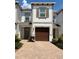 Charming two-story townhome featuring a one-car garage and well-maintained front yard with lovely brick-paved driveway at 18875 Noble Caspian Dr, Lutz, FL 33558