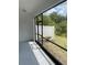 A screened in patio presents a tranquil view of the green backyard space enclosed with a white fence at 18875 Noble Caspian Dr, Lutz, FL 33558
