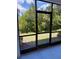View from screened lanai showcasing the lush backyard, providing a serene outdoor living space at 18875 Noble Caspian Dr, Lutz, FL 33558