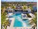 Resort-style community pool with palm trees and lounge chairs at 18875 Noble Caspian Dr, Lutz, FL 33558
