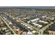 Expansive aerial view of a waterfront community featuring homes with canal access and well-manicured lawns at 260 Coronado Dr, Punta Gorda, FL 33950
