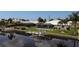 Waterfront property with screened lanai, dock, and lush landscaping, perfect for enjoying outdoor living at 260 Coronado Dr, Punta Gorda, FL 33950