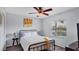 Well-lit bedroom with a queen-size bed, ceiling fan, and a view of the outdoors at 260 Coronado Dr, Punta Gorda, FL 33950