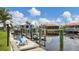 Private dock with a sunny blue chair and waterfront access for boating and enjoying the coastal lifestyle at 260 Coronado Dr, Punta Gorda, FL 33950