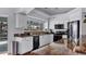 Updated kitchen with white cabinetry, granite countertops, black appliances, and an abundance of light at 260 Coronado Dr, Punta Gorda, FL 33950