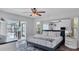 Comfortable main bedroom featuring a king bed, ceiling fan, and sliding door access to outdoor pool area at 260 Coronado Dr, Punta Gorda, FL 33950