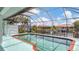 Screened-in pool with brick trim and canal view; perfect for relaxing and enjoying waterfront living at 260 Coronado Dr, Punta Gorda, FL 33950