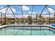 A serene screened pool overlooks a scenic canal, perfect for relaxing and enjoying waterfront views at 260 Coronado Dr, Punta Gorda, FL 33950