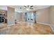 Spacious living room features travertine floors, lots of natural light, and access to the kitchen at 4239 Brentwood Park Cir, Tampa, FL 33624