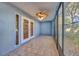 Charming sunroom with tile flooring, ceiling fan, and a wall of windows at 4239 Brentwood Park Cir, Tampa, FL 33624