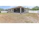 A backyard with a screen lanai and white vinyl fence at 11621 Ashton Field Ave, Riverview, FL 33579