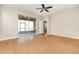 A bedroom with wood floors leads to a screened-in porch at 11621 Ashton Field Ave, Riverview, FL 33579
