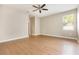 A spacious bedroom features laminate floors, a ceiling fan, and a window at 11621 Ashton Field Ave, Riverview, FL 33579