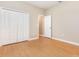 Bedroom features wood floors, a spacious closet, and a doorway at 11621 Ashton Field Ave, Riverview, FL 33579