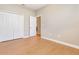 A standard bedroom features wood floors and a closet with bi-fold doors at 11621 Ashton Field Ave, Riverview, FL 33579