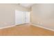A standard bedroom features wood floors and a closet with bi-fold doors at 11621 Ashton Field Ave, Riverview, FL 33579