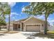 Traditional home with attached two-car garage, desert landscaping and neutral paint at 11621 Ashton Field Ave, Riverview, FL 33579