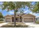 Charming single-story home featuring a two-car garage, manicured lawn, and inviting front entrance at 11621 Ashton Field Ave, Riverview, FL 33579