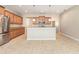 Bright, functional kitchen boasting stainless steel appliances and granite countertops and tiled flooring at 11621 Ashton Field Ave, Riverview, FL 33579