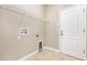Bright laundry room with tile floors and a door to the outside at 11621 Ashton Field Ave, Riverview, FL 33579