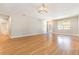 Inviting living room featuring wood flooring, neutral walls, and modern lighting fixtures for a comfortable ambiance at 11621 Ashton Field Ave, Riverview, FL 33579