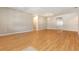 Open living room with hardwood floors, neutral walls and a light fixture at 11621 Ashton Field Ave, Riverview, FL 33579
