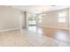 Bright living area with wood flooring leading to a sunroom, offering versatile living space at 11621 Ashton Field Ave, Riverview, FL 33579