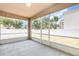 A screened-in lanai/patio overlooking the backyard and white vinyl fence at 11621 Ashton Field Ave, Riverview, FL 33579