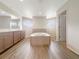 Bright bathroom boasts a soaking tub, double vanity, and modern fixtures at 13210 Essman Ave, Port Charlotte, FL 33953