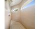 Bright bathroom featuring a tiled shower with arched windows for natural light at 13210 Essman Ave, Port Charlotte, FL 33953