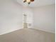 Light-filled bedroom with carpet and double doors with view into another room at 13210 Essman Ave, Port Charlotte, FL 33953