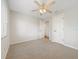 Neutral-toned bedroom with plush carpet, ceiling fan, and plenty of sunlight at 13210 Essman Ave, Port Charlotte, FL 33953