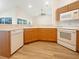 Well-lit kitchen featuring modern appliances and warm wood cabinets at 13210 Essman Ave, Port Charlotte, FL 33953