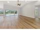 Bright, open living space with wood-look floors and views of the pool at 13210 Essman Ave, Port Charlotte, FL 33953