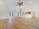 Bright living room features a ceiling fan, and beautiful wood-look flooring at 13210 Essman Ave, Port Charlotte, FL 33953